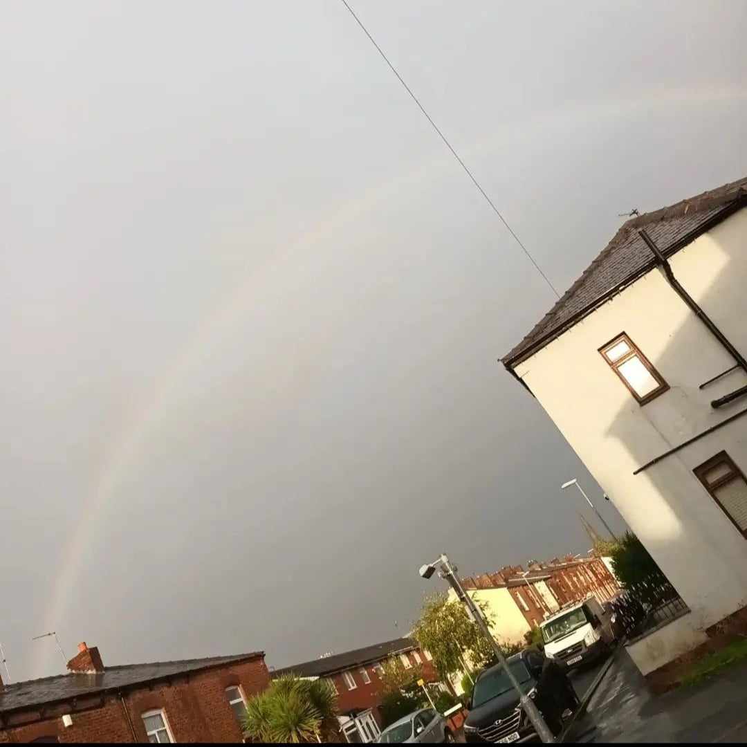  Sara was on her way to Manchester when she saw a Full rainbow appear while walking she took a photo quickly before it went as a full rainbow doesn't come often. The rainbow has red, yellow, blue and green covering the flow in a grey-looking cloud.