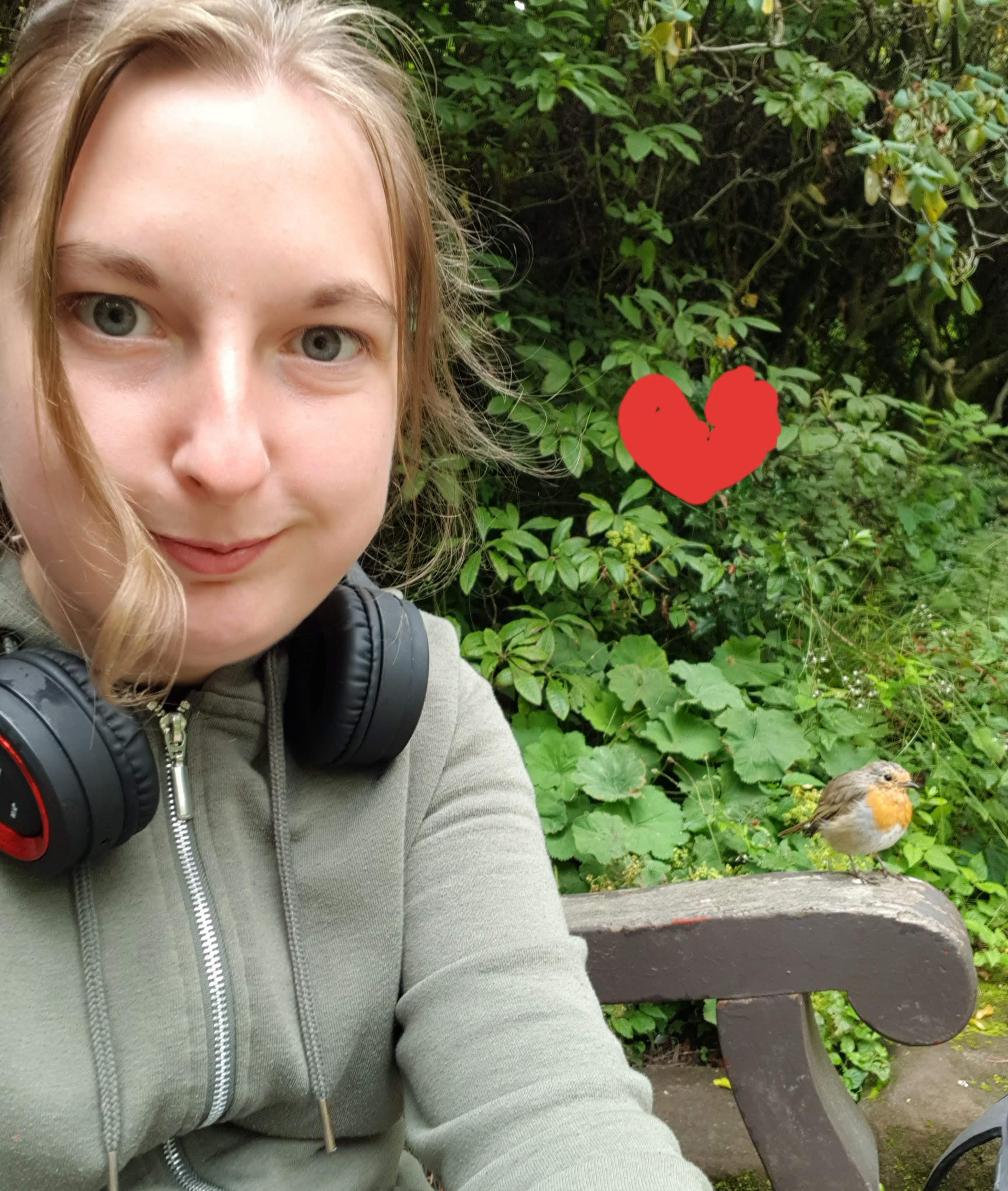  Sara went to Didsbury to the park and she sat down to have lunch a very brave red and brown Robin popped out of the brushes to take some of Sara's wrap and flew down landed on Sara's lap and bounced off and landed on the bench. In amusement Sara took a Selfie with the Robin and gave the Robin some food and chilled with Sara for a while.